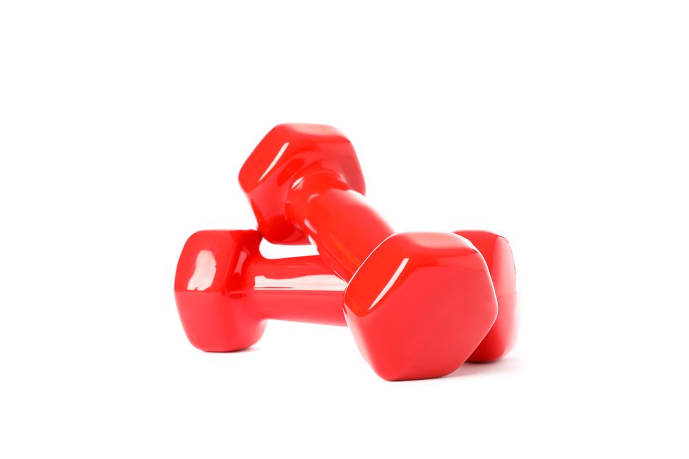 Red dumbbells for fitness isolated on plain background