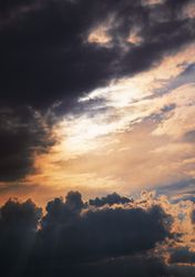 Vertical orientation of grey clouds in evening sky