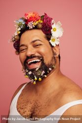 Cheerful male with flowers in hair and beard 42qld5