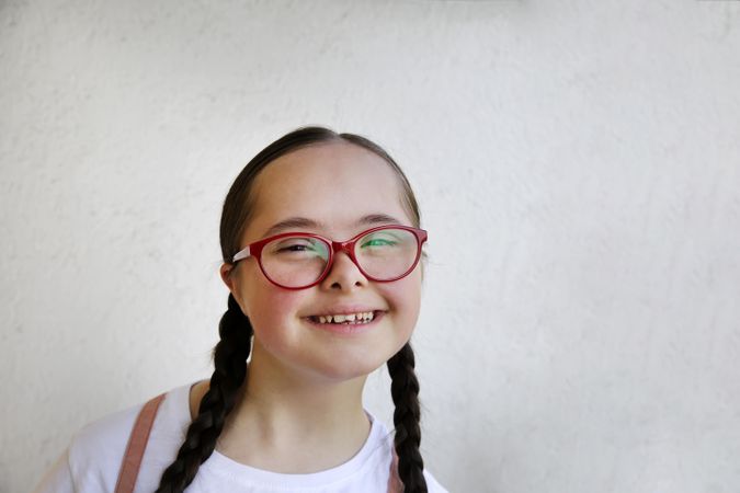 Young girl smiling and wearing glasses