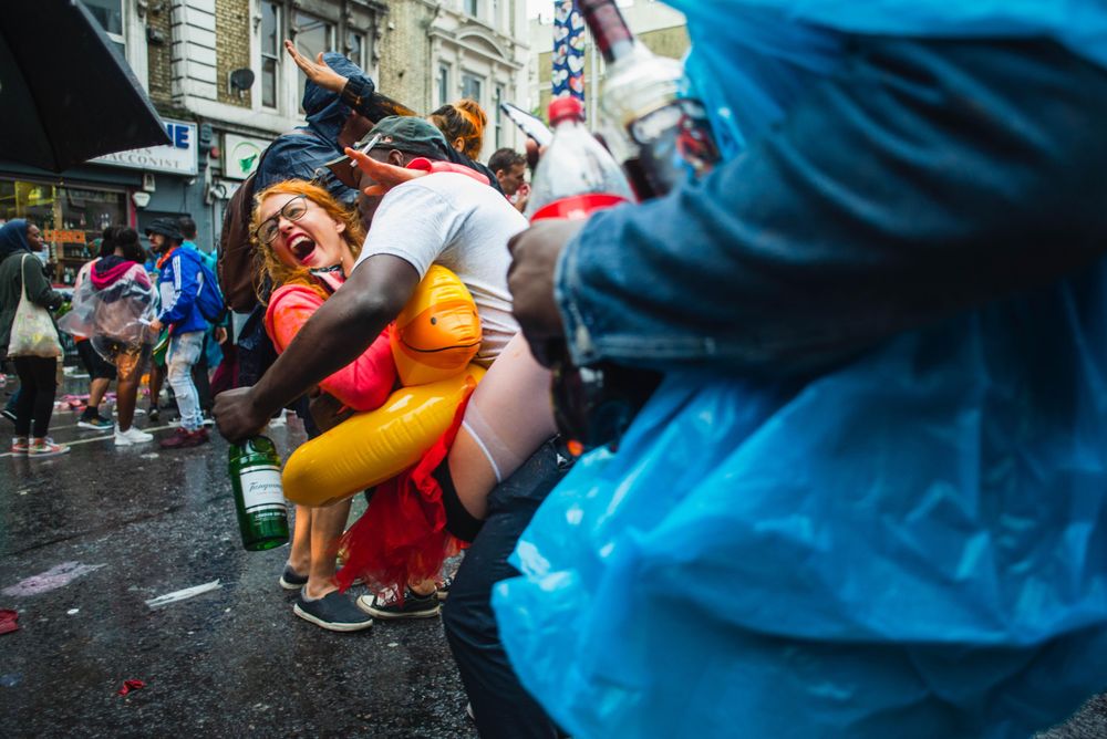 Young red haired woman laughs during attempted kiss in street party