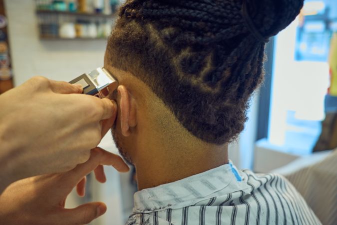 Anonymous hairstylist doing a haircut