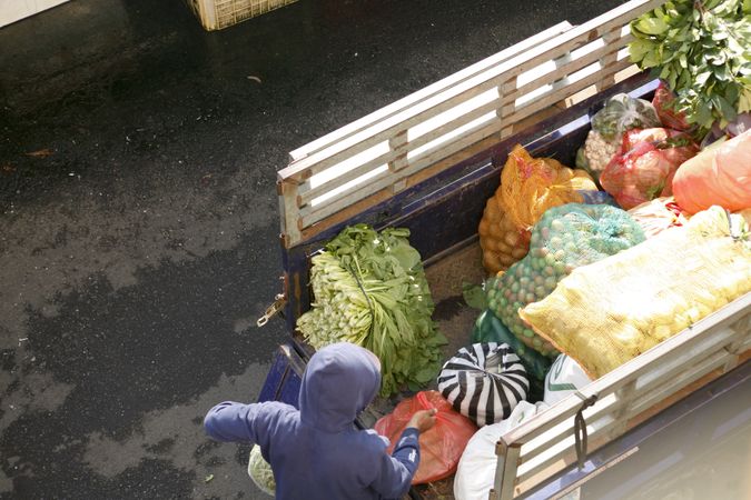 Truck of fresh fruit and vegetables being unloaded at market