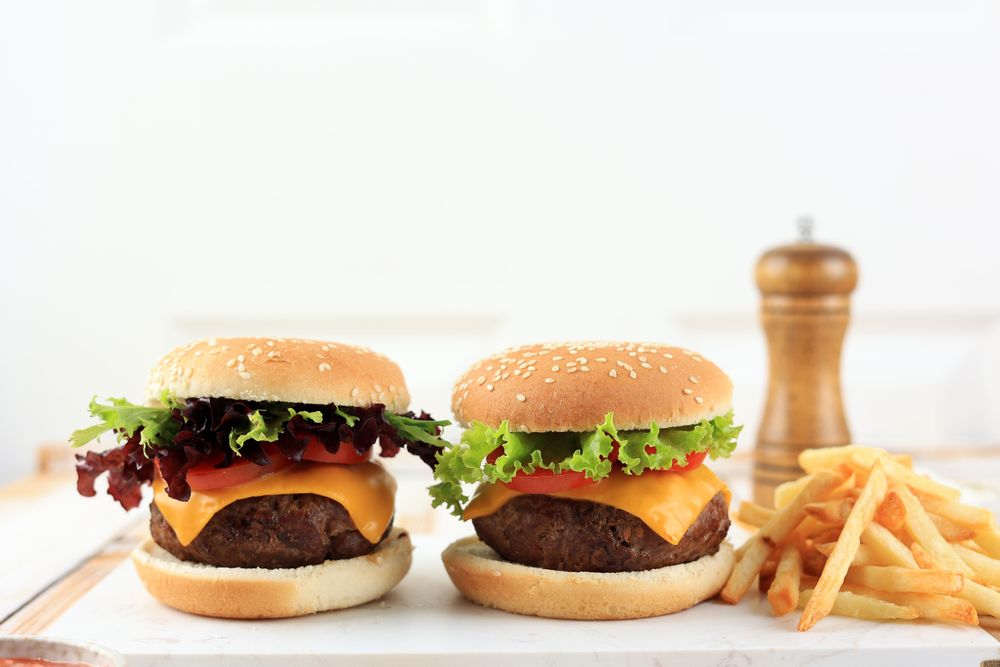Two Homemade Burger with French Fries on Wooden Table