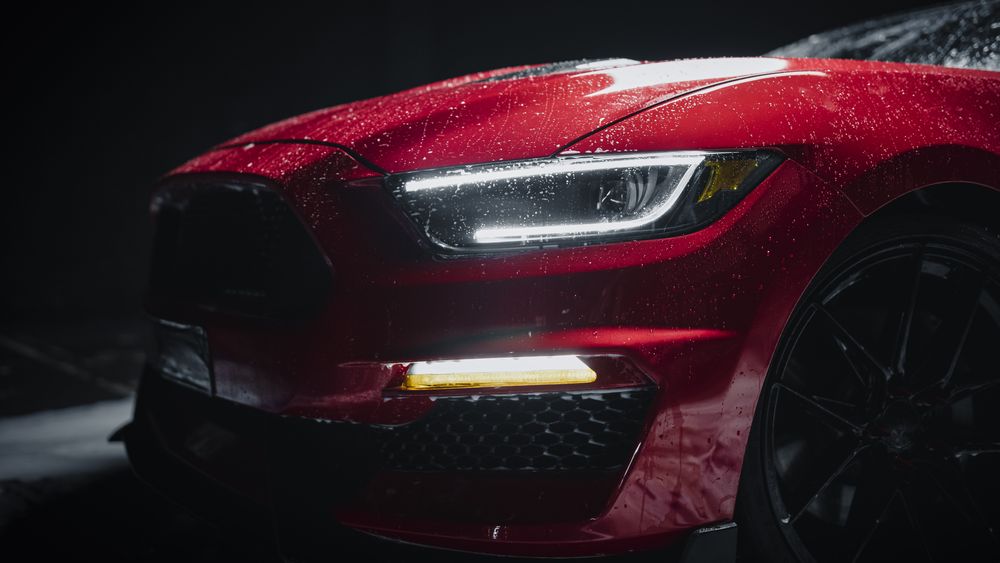 Close Up of a Modern Red Performance Car in a Dark Studio Environment.