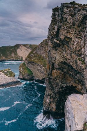 Sea waves crashing near cliff
