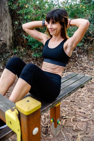 Sportswoman training on an abdominal bench