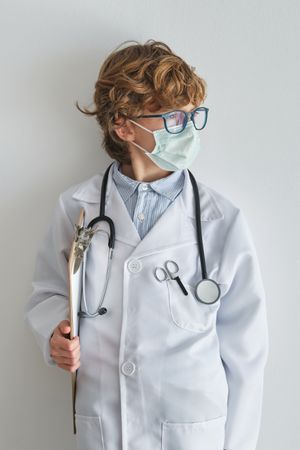 Boy doctor in sterile mask and medical robe