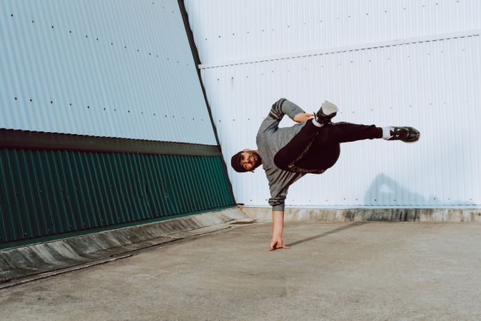 Man performing handstand near wall