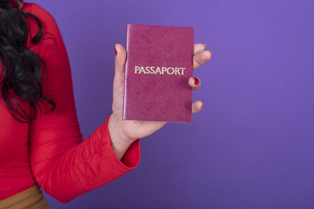 Female hand holding a passport
