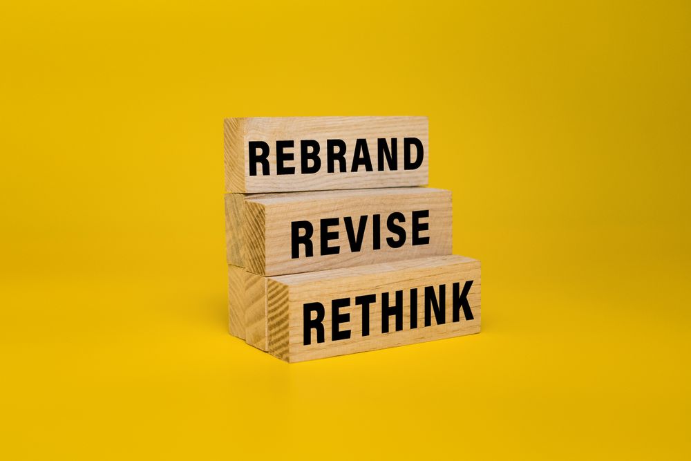 rethink revise and rebrand words on wooden blocks isolated on yellow background