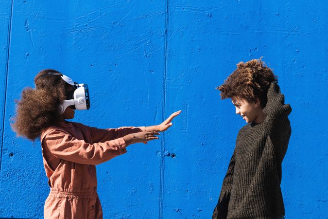 Black kids with VR headset getting experience with virtual world