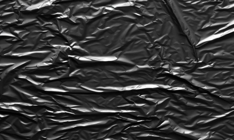 dark crumpled and creased plastic poster texture background