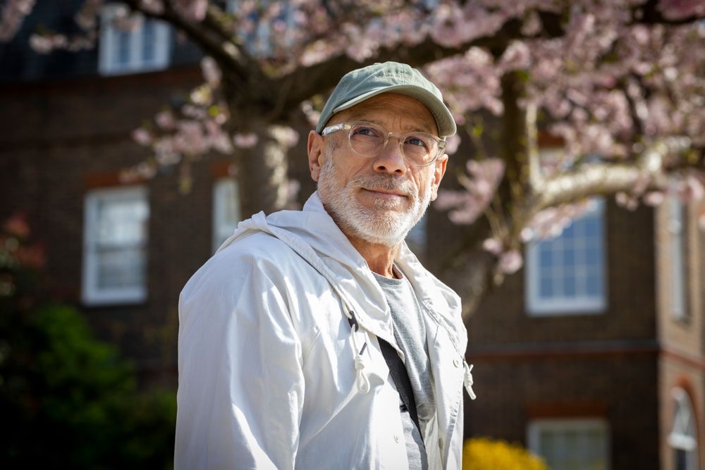 Portrait of smiling male with grey beard with cherry blossom tree