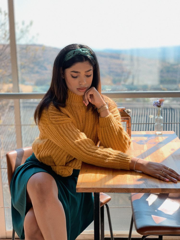 Woman sitting at table looking down