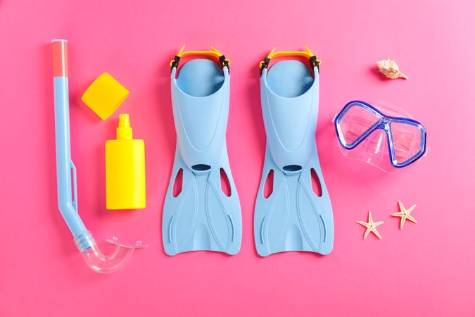 Sea vacation accessories on yellow background, top view