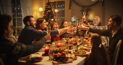 Portrait of a Handsome Young Black Man Proposing a Toast at a Christmas Dinner Table.