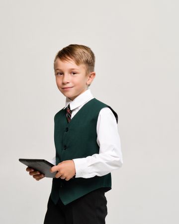 Portrait preteen schoolboy with tablet PC on white background