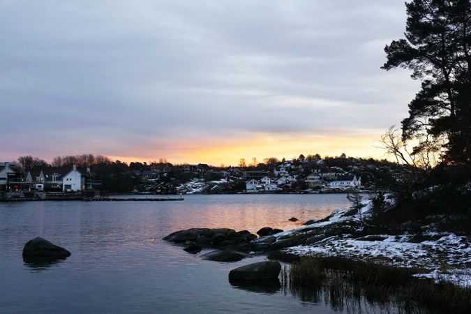 Picturesque view of town on snowy hilly shore