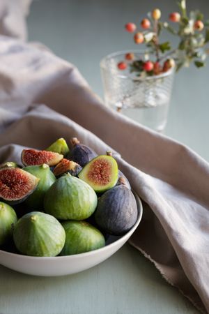 Plate of fresh ripe figs on kitchen table