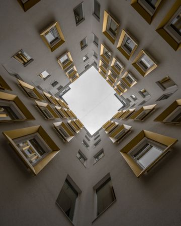 Vertical low angle view of high ceiling building with golden windows