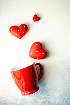 Red mug and dotted heart decorations for St. Valentine's day card