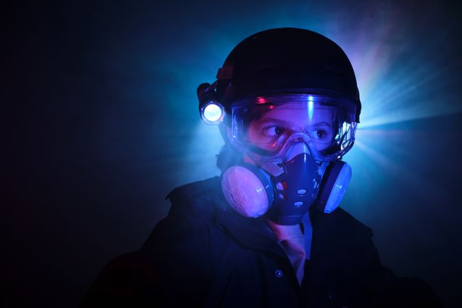 Thief in gas mask in darkness