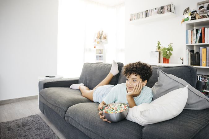 Girl watching tv in living room