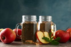 Composition with cider and apples on gray table