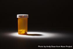 Medicine Bottle and Pills Under Spot Light 47m7JO