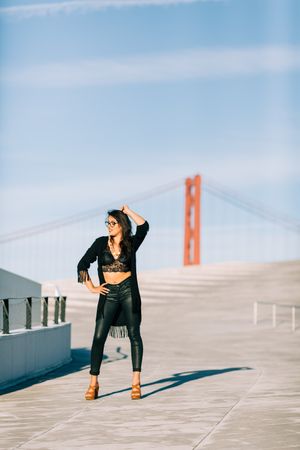 Trendy female standing on urban background