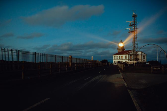 Road and lighthouse in evening