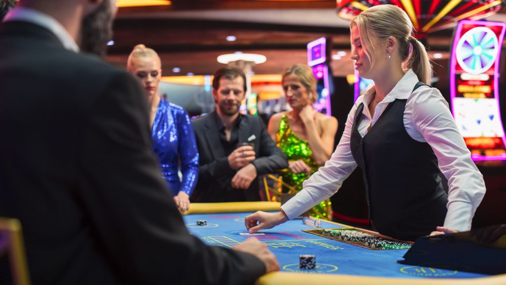 Happy and Cheerful Group of Casino Guests Placing Bets and Celebrating Winning Luck and Skill in Baccarat.