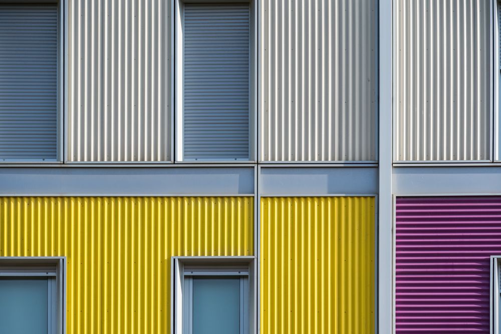 Facade of modern multicolored building with narrow windows