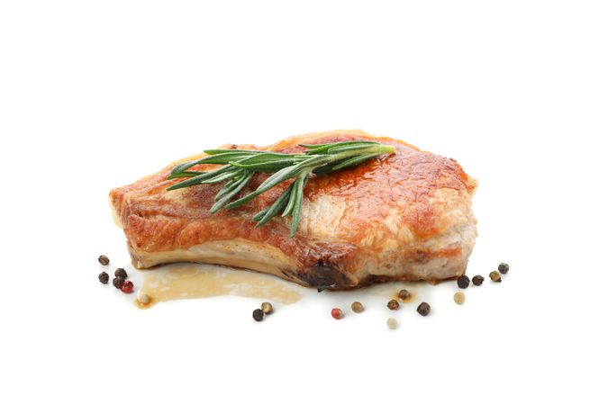 Fried pork steak isolated on light background. Grilled food