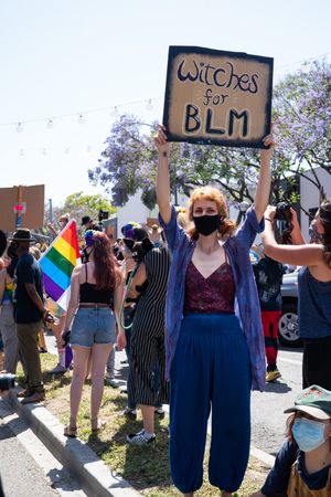 Los Angeles, CA, USA — June 14th, 2020: woman holding protest sign that says “witches for BLM”