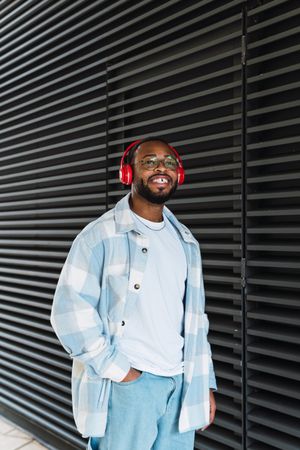 Smiling Black man in headphones and jacket