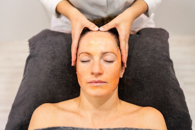 Female client receiving relaxing facial