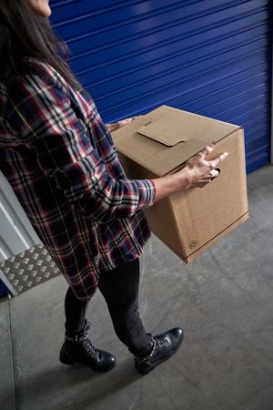 Anonymous woman with carton box