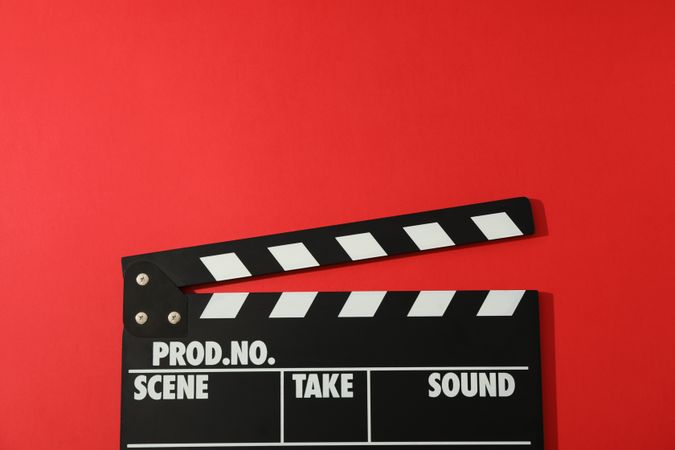 clapperboard on red background, space for text