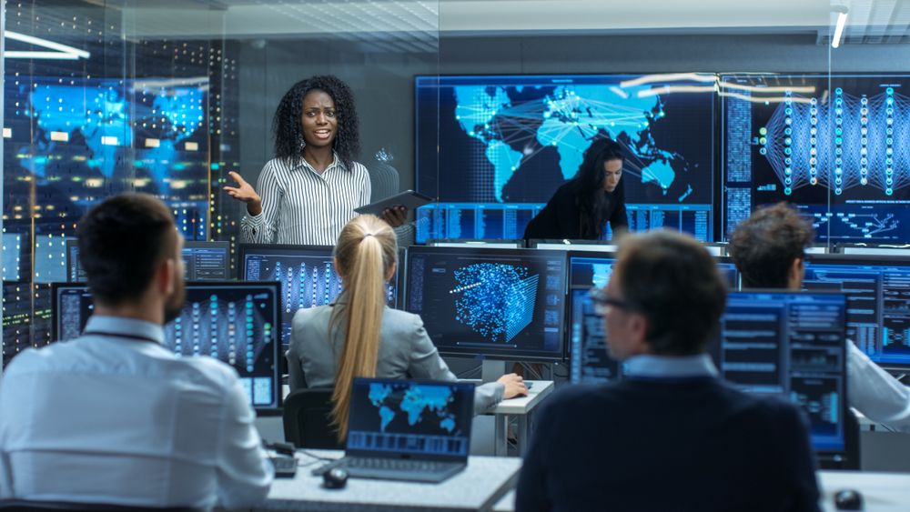 Chief Project Engineer Holds Briefing for a Team of Scientists that are Building Machine Learning System.