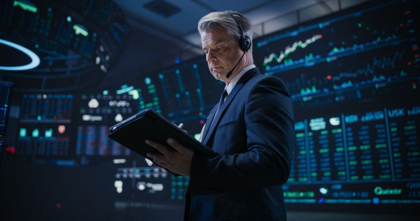 Low Angle Portrait of a Proactive Stock Exchange Manager Working in Modern Office.