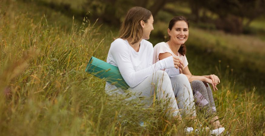Women friends relaxing in a park after a workout