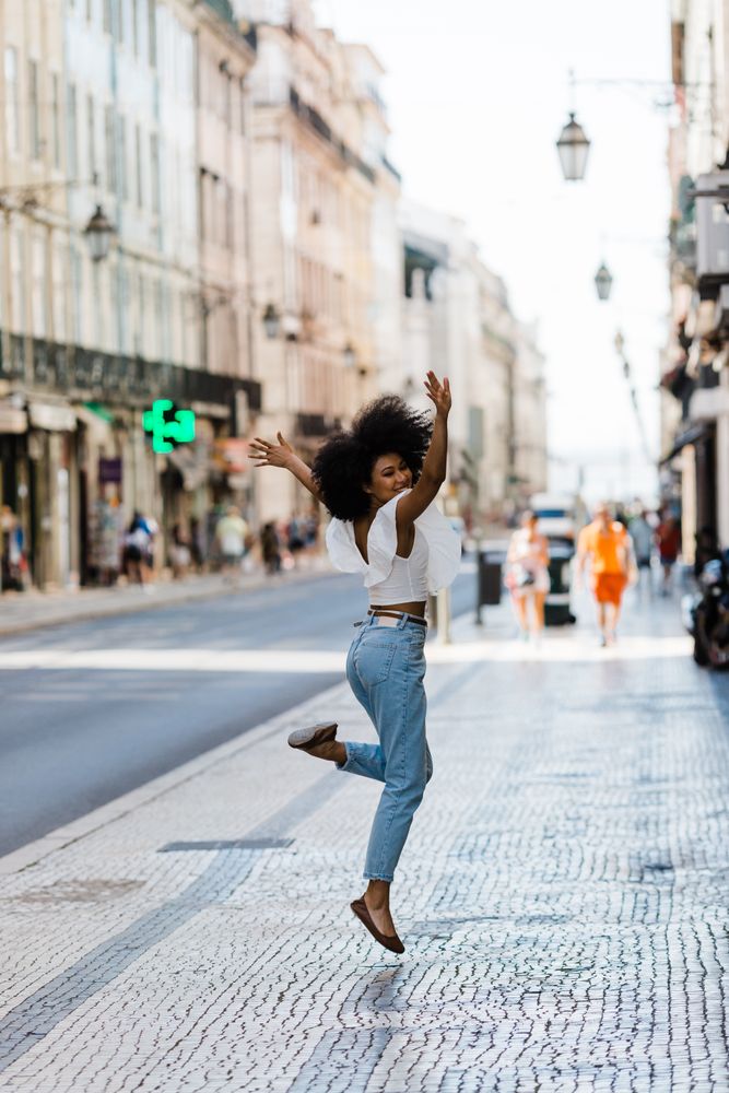 Black female jumping on urban background