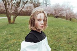 Cute girl near blooming trees