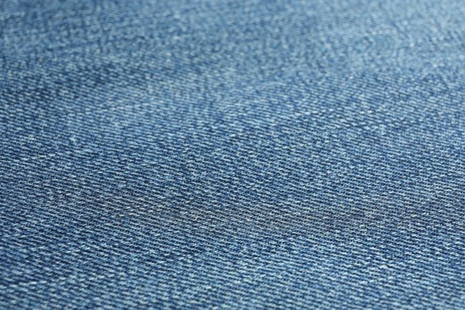 Texture of blue jeans as background, space for text