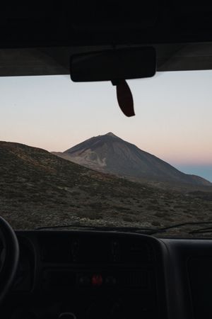 View of mountain through window of car