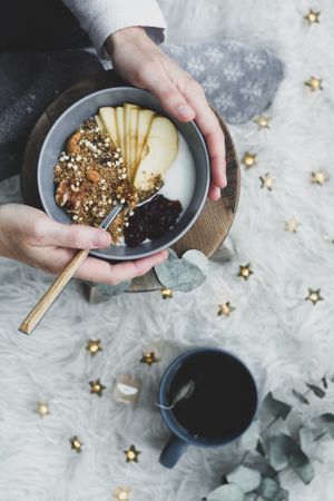 Faceless woman taking healthy breakfast bowl