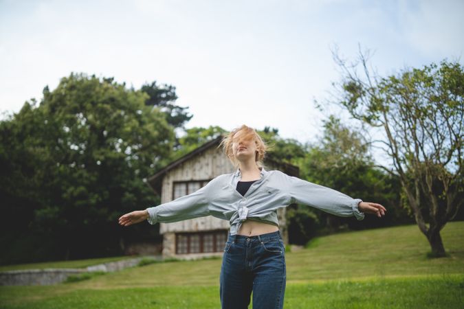 Content female dancing on grass in countryside