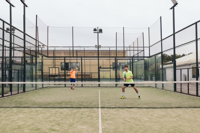 Two young man playing paddle tennis